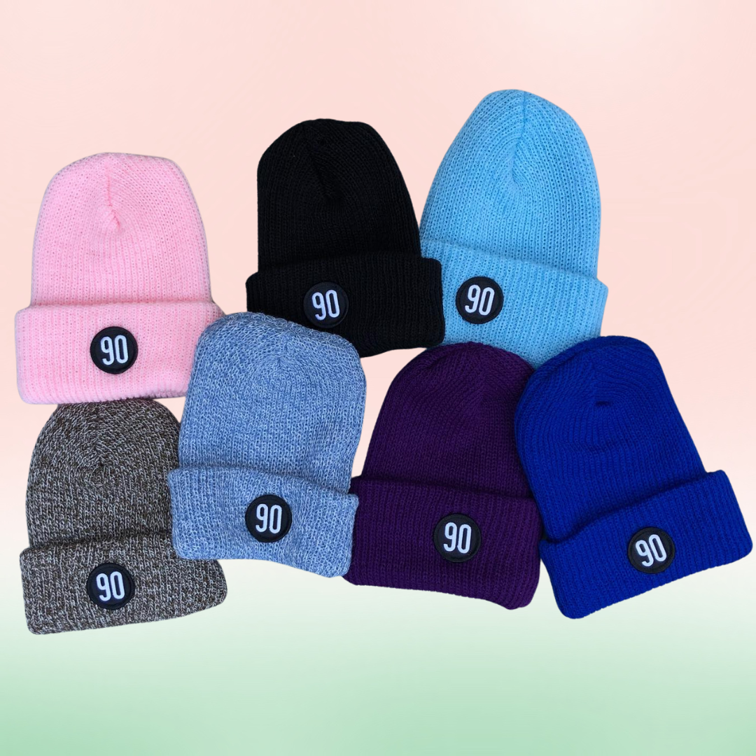 Colorful collection of 90 The Original Beanies presented with a pastel gradient background.