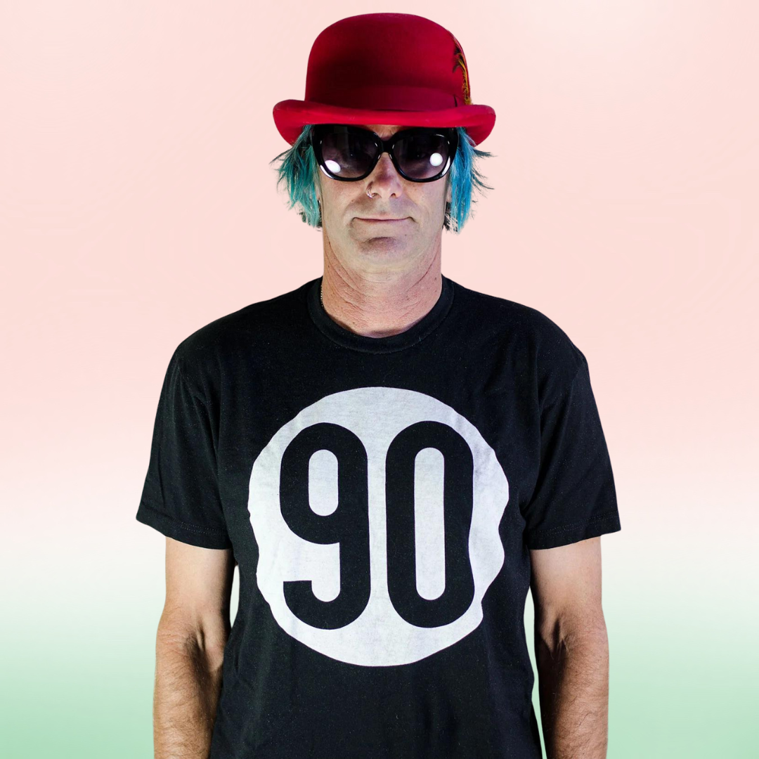 Fashion-forward individual in 90 The Original Black Tee topped with a red hat, showcasing the classic '90' front logo