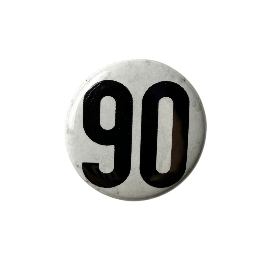 Classic white 90 The Original enamel pin with bold logo.
