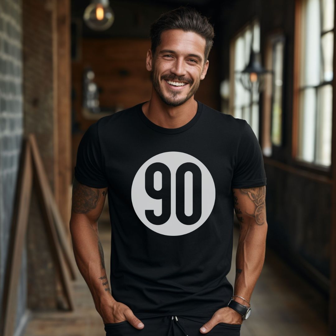 Charming man with a smile, wearing the 90 The Original black tee, representing the authentic '90s vibe.