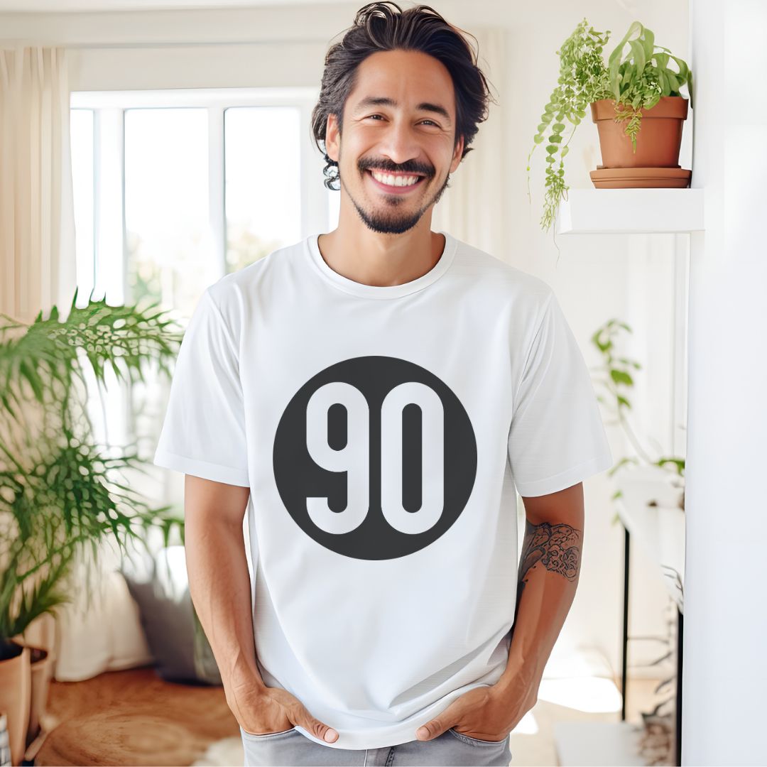 Happy man at home in a white 90 The Original tee, embodying a relaxed and classic style.